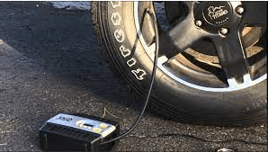 An Air Compressor To Fill A Tire